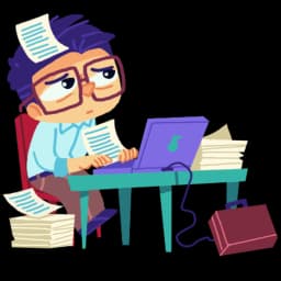 Nauczyciel przy laptopie, otoczony dokumentacją